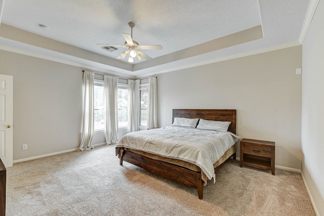 bedroom with ornamental molding, light carpet, a textured ceiling, and ceiling fan