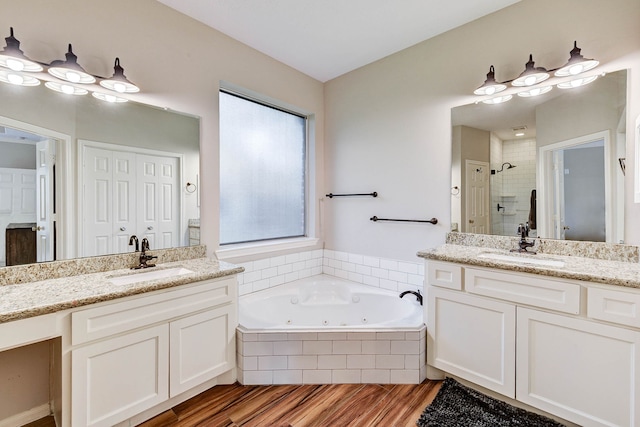 bathroom featuring vanity, shower with separate bathtub, and hardwood / wood-style flooring