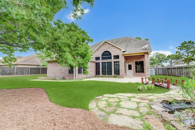 back of property featuring a patio area and a yard