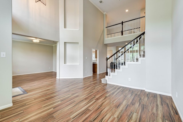 foyer with hardwood / wood-style floors and a high ceiling