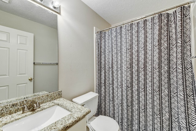 bathroom with vanity, a shower with curtain, a textured ceiling, and toilet