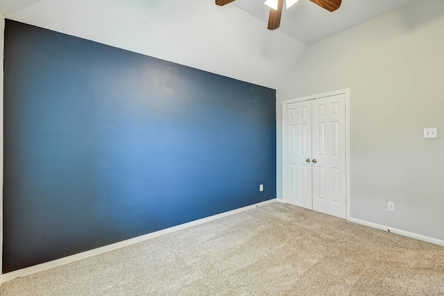 carpeted spare room with high vaulted ceiling and ceiling fan