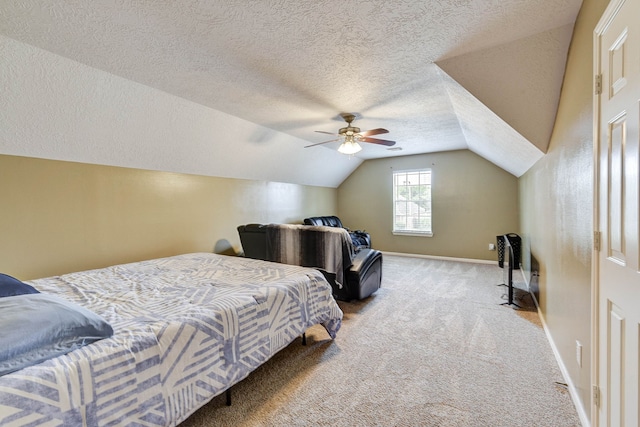 bedroom with ceiling fan, a textured ceiling, vaulted ceiling, and carpet floors