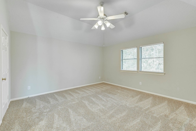 carpeted spare room with ceiling fan