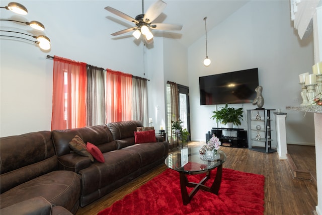 living room with ceiling fan, high vaulted ceiling, and dark hardwood / wood-style flooring