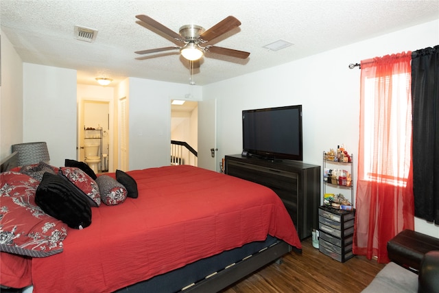 bedroom with dark wood-type flooring, ceiling fan, a textured ceiling, and ensuite bathroom