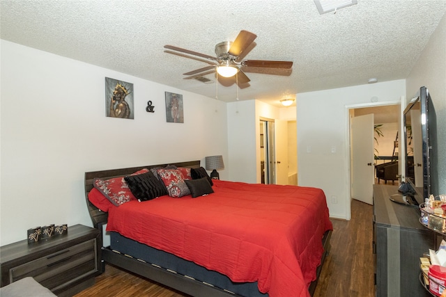 bedroom featuring dark wood-type flooring, a textured ceiling, and ceiling fan