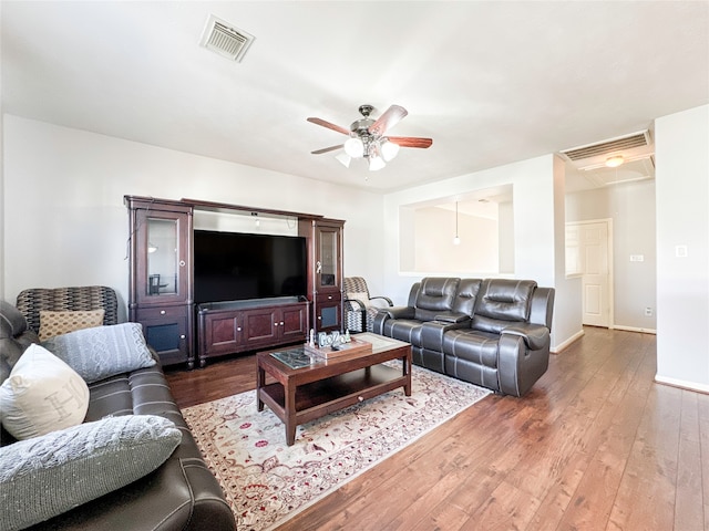 living room featuring hardwood / wood-style floors and ceiling fan