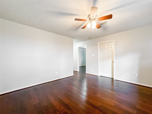 empty room featuring ceiling fan and dark hardwood / wood-style flooring