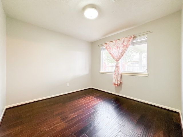 unfurnished room featuring dark hardwood / wood-style floors