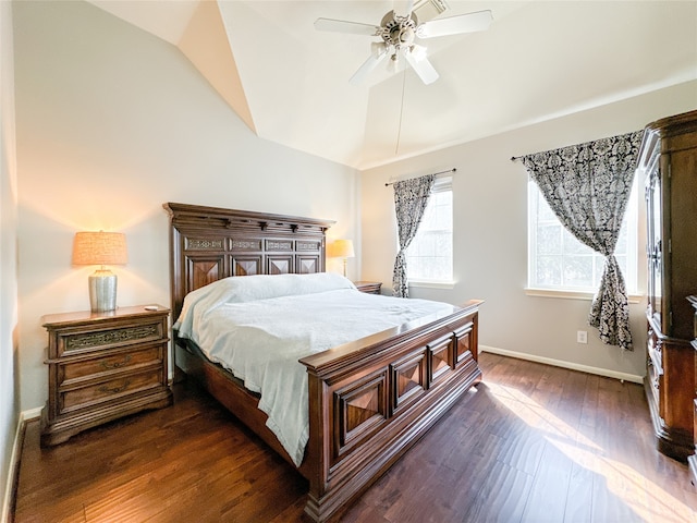 bedroom featuring dark wood-type flooring, vaulted ceiling, and ceiling fan