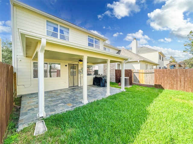 back of property with a yard, ceiling fan, a patio, and central air condition unit