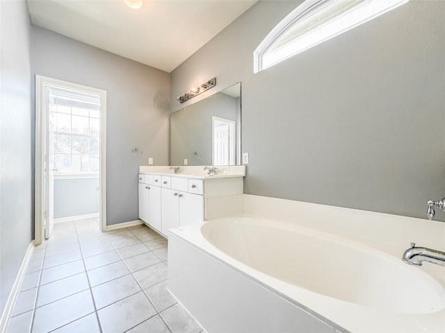 bathroom with vanity, tile patterned floors, and a bathtub