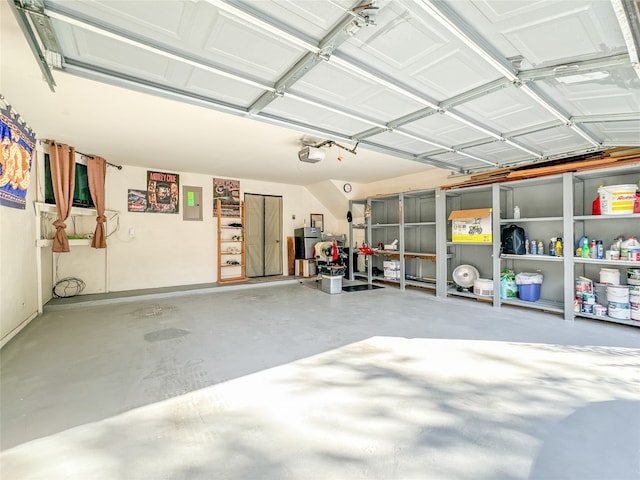 garage featuring a garage door opener, electric panel, and water heater