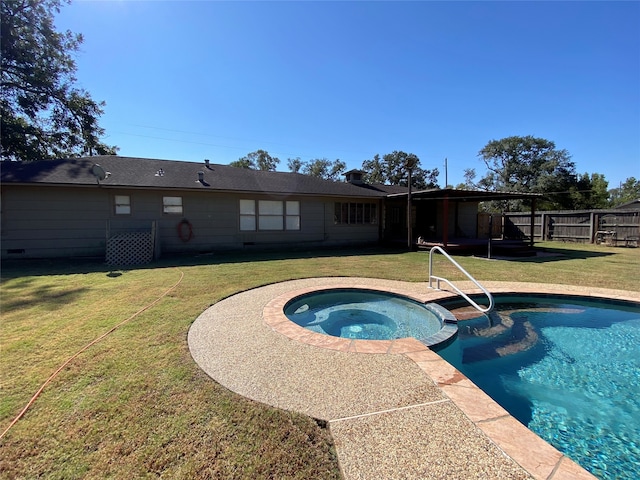 view of swimming pool with an in ground hot tub and a lawn