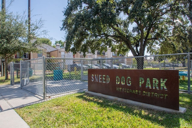 community / neighborhood sign with a yard