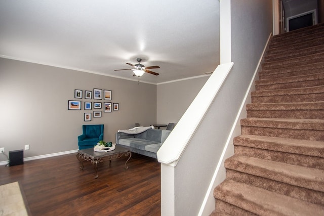 stairway with crown molding, hardwood / wood-style flooring, and ceiling fan