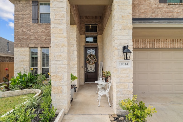 view of exterior entry with a garage