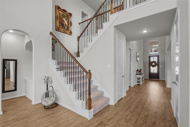 entryway featuring a high ceiling and wood-type flooring