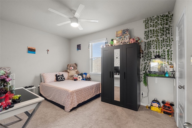 bedroom featuring ceiling fan and light colored carpet