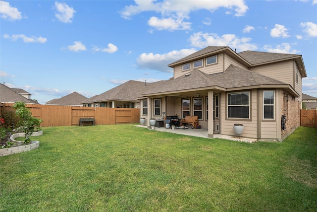 back of property featuring a yard and a patio area