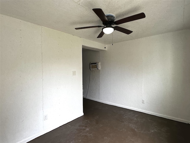 unfurnished room with an AC wall unit and ceiling fan