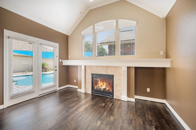 unfurnished living room with dark wood-type flooring, crown molding, vaulted ceiling, and plenty of natural light