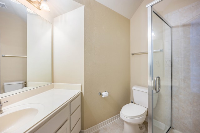 bathroom with a shower with door, toilet, tile patterned floors, and vanity