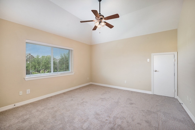 spare room featuring light colored carpet, high vaulted ceiling, and ceiling fan