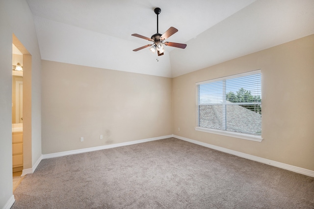 carpeted empty room with ceiling fan and vaulted ceiling