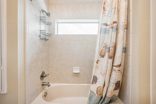 bathroom featuring shower / bath combo with shower curtain