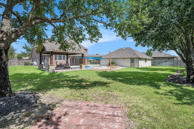 view of yard with a patio and a fenced in pool