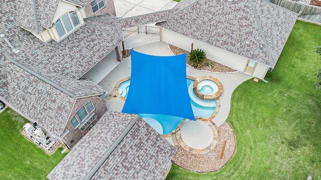 view of swimming pool featuring a patio area and a lawn