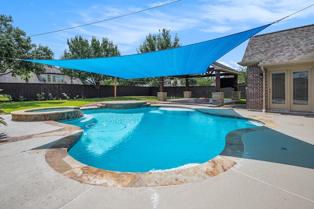 view of swimming pool featuring an in ground hot tub and a patio