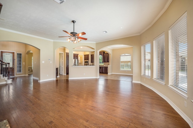 unfurnished living room featuring crown molding, dark hardwood / wood-style floors, and ceiling fan