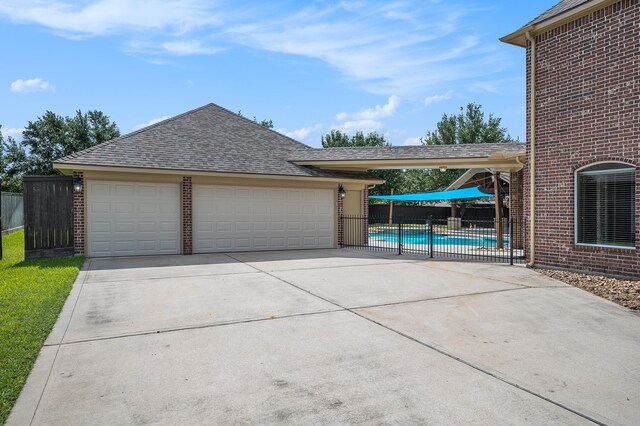 garage with a fenced in pool