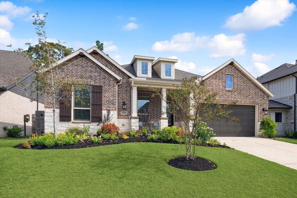 view of front of house with a front yard and a garage