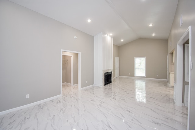 unfurnished living room featuring high vaulted ceiling