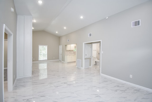 empty room featuring high vaulted ceiling