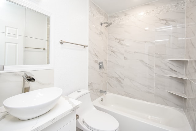 full bathroom featuring toilet, vanity, and tiled shower / bath