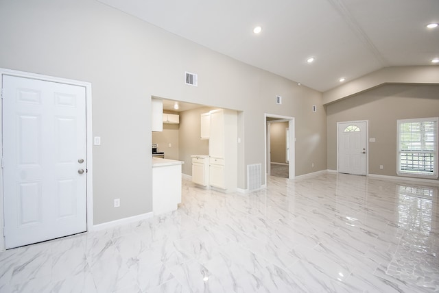 unfurnished living room with vaulted ceiling