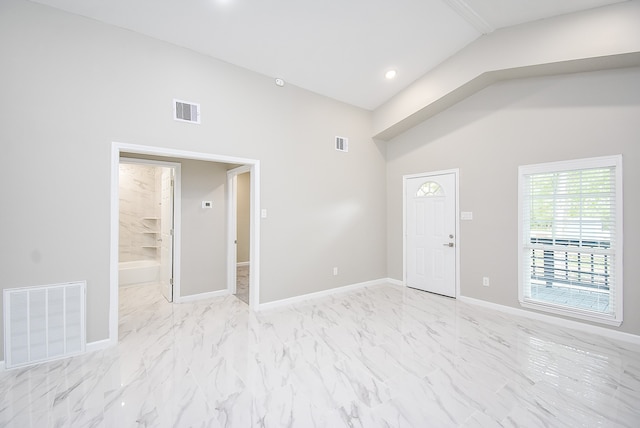 spare room featuring vaulted ceiling