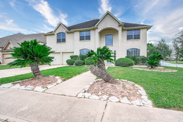 view of front of property featuring a front yard and a garage