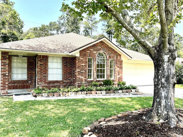 4219 Hermitage Hollow Ln, Kingwood, TX 77339 - ranch-style house featuring brick siding, roof with shingles, an attached garage, a front lawn, and driveway