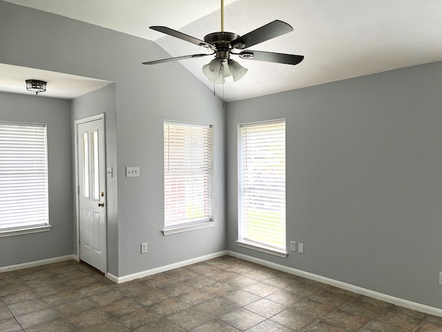 spare room with plenty of natural light, ceiling fan, and vaulted ceiling