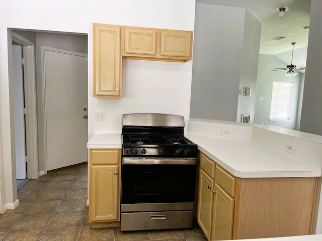 4219 Hermitage Hollow Ln, Kingwood, TX 77339 - kitchen with stainless steel range with gas cooktop, a peninsula, a ceiling fan, light countertops, and vaulted ceiling