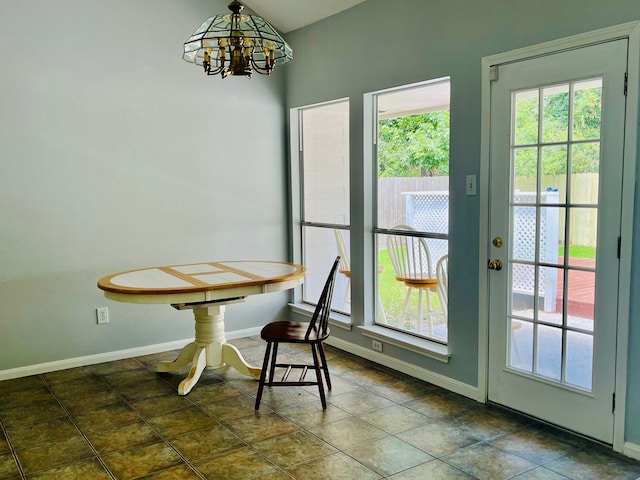 unfurnished dining area with a wealth of natural light and a notable chandelier