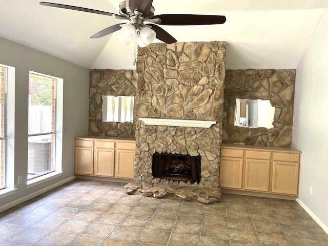 4219 Hermitage Hollow Ln, Kingwood, TX 77339 - unfurnished living room featuring baseboards, a ceiling fan, a stone fireplace, and lofted ceiling