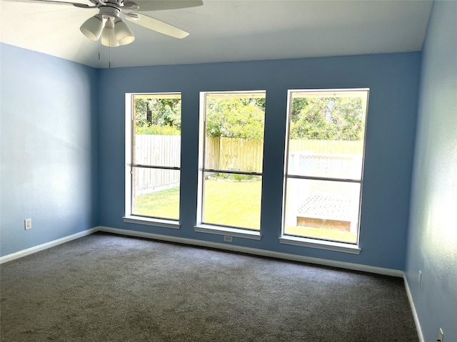 unfurnished room featuring ceiling fan and carpet floors