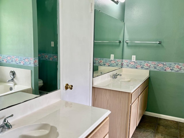 4219 Hermitage Hollow Ln, Kingwood, TX 77339 - bathroom featuring toilet, vanity, tile patterned floors, a bath, and baseboards